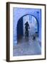 Morocco, Chefchaouen. Bicyclist Rides Past Cat in Archway in the Blue Village of Chefchaouen-Brenda Tharp-Framed Photographic Print