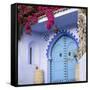 Morocco, Chefchaouen. Bougainvillea Blossoms Frame an Ornate Blue Door-Brenda Tharp-Framed Stretched Canvas