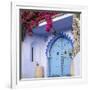 Morocco, Chefchaouen. Bougainvillea Blossoms Frame an Ornate Blue Door-Brenda Tharp-Framed Photographic Print