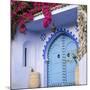 Morocco, Chefchaouen. Bougainvillea Blossoms Frame an Ornate Blue Door-Brenda Tharp-Mounted Photographic Print