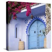 Morocco, Chefchaouen. Bougainvillea Blossoms Frame an Ornate Blue Door-Brenda Tharp-Stretched Canvas