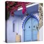 Morocco, Chefchaouen. Bougainvillea Blossoms Frame an Ornate Blue Door-Brenda Tharp-Stretched Canvas