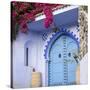 Morocco, Chefchaouen. Bougainvillea Blossoms Frame an Ornate Blue Door-Brenda Tharp-Stretched Canvas