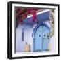 Morocco, Chefchaouen. Bougainvillea Blossoms Frame an Ornate Blue Door-Brenda Tharp-Framed Photographic Print