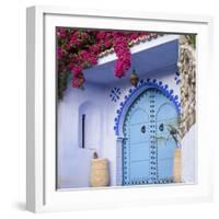 Morocco, Chefchaouen. Bougainvillea Blossoms Frame an Ornate Blue Door-Brenda Tharp-Framed Photographic Print