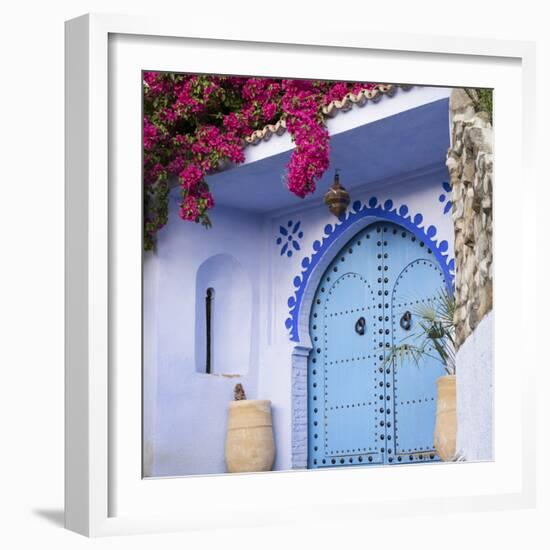 Morocco, Chefchaouen. Bougainvillea Blossoms Frame an Ornate Blue Door-Brenda Tharp-Framed Photographic Print