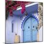 Morocco, Chefchaouen. Bougainvillea Blossoms Frame an Ornate Blue Door-Brenda Tharp-Mounted Photographic Print