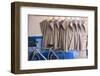 Morocco, Essaouira, Djellabas Hanging on Wall Next to Bicycle-Emily Wilson-Framed Photographic Print