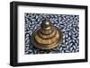 Morocco, Fes. A covered brass bowl with inlay of camel bone sites on a stone inlay table in a shop.-Brenda Tharp-Framed Photographic Print