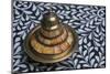 Morocco, Fes. A covered brass bowl with inlay of camel bone sites on a stone inlay table in a shop.-Brenda Tharp-Mounted Photographic Print