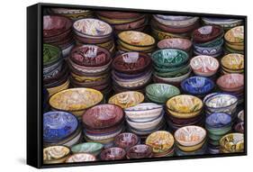 Morocco, Marrakech. Colorfully painted ceramic bowls for sale in a souk, a shop.-Brenda Tharp-Framed Stretched Canvas