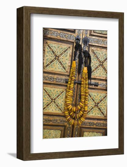 Morocco, Tinerhir. Traditional necklace of Berber woman hangs on a cabinet with camel-bone inlay-Brenda Tharp-Framed Photographic Print