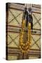 Morocco, Tinerhir. Traditional necklace of Berber woman hangs on a cabinet with camel-bone inlay-Brenda Tharp-Stretched Canvas