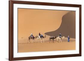 Morocco. Tourists ride camels in Erg Chebbi in the Sahara desert.-Brenda Tharp-Framed Premium Photographic Print