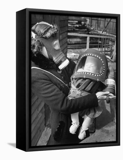 Mother and Baby Wearing Gas Masks During Gas Preparations Test During WWII-Hans Wild-Framed Stretched Canvas