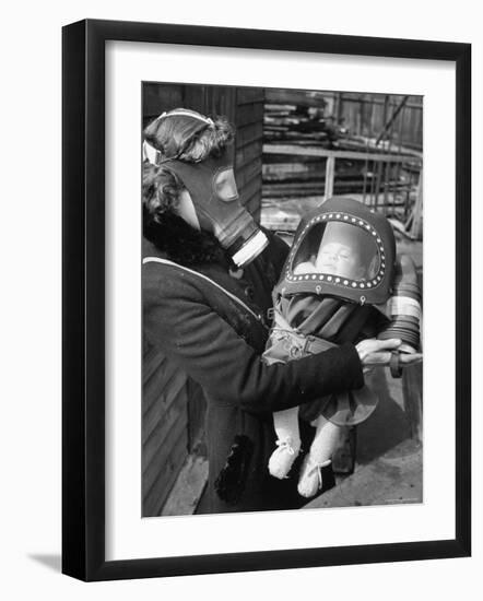 Mother and Baby Wearing Gas Masks During Gas Preparations Test During WWII-Hans Wild-Framed Premium Photographic Print