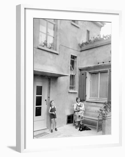 Mother with Her Two Sons in the Courtyard of their German Home, Ca. 1946-null-Framed Photographic Print