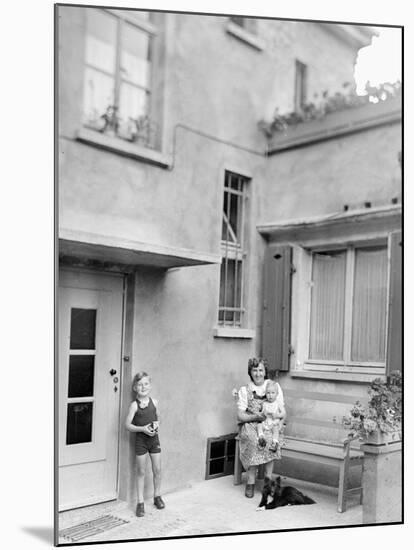 Mother with Her Two Sons in the Courtyard of their German Home, Ca. 1946-null-Mounted Photographic Print