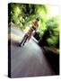 Motion Blurred Image of a Female Cyclist-null-Stretched Canvas