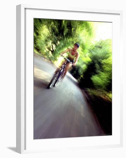 Motion Blurred Image of a Female Cyclist-null-Framed Photographic Print