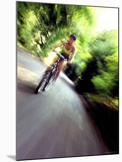 Motion Blurred Image of a Female Cyclist-null-Mounted Photographic Print