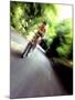 Motion Blurred Image of a Female Cyclist-null-Mounted Photographic Print