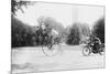 Motorcycle Cop Chases a Penny Farthing Velocipede Down a DC Street with Washington Monument in Back-null-Mounted Art Print