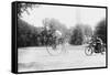 Motorcycle Cop Chases a Penny Farthing Velocipede Down a DC Street with Washington Monument in Back-null-Framed Stretched Canvas