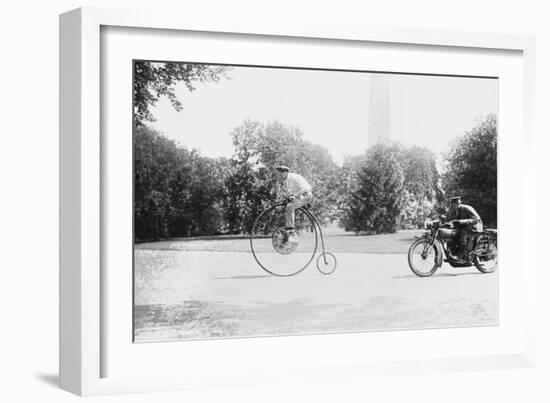 Motorcycle Cop Chases a Penny Farthing Velocipede Down a DC Street with Washington Monument in Back-null-Framed Art Print