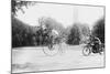 Motorcycle Cop Chases a Penny Farthing Velocipede Down a DC Street with Washington Monument in Back-null-Mounted Art Print