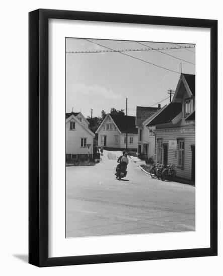 Motorcycle Going Down Street in Small Town-null-Framed Photographic Print