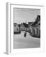 Motorcycle Going Down Street in Small Town-null-Framed Photographic Print