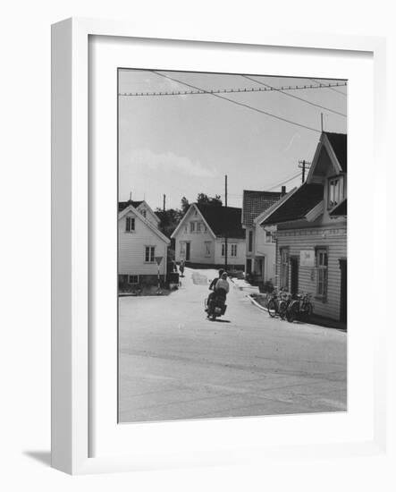 Motorcycle Going Down Street in Small Town-null-Framed Photographic Print