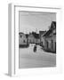 Motorcycle Going Down Street in Small Town-null-Framed Photographic Print