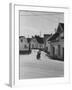 Motorcycle Going Down Street in Small Town-null-Framed Photographic Print