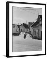 Motorcycle Going Down Street in Small Town-null-Framed Photographic Print