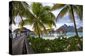 Mount Otemanu In The Distance Of The Over Water Bungalows At The Four Seasons Bora Bora-Karine Aigner-Stretched Canvas