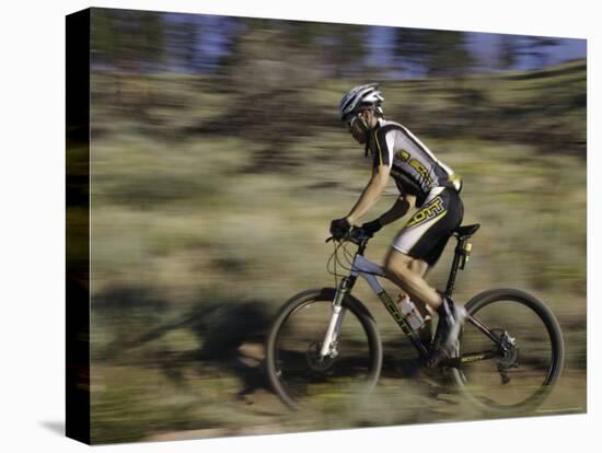 Mountain Biker Against a Blurry Background, Mt. Bike-Michael Brown-Stretched Canvas