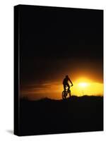 Mountain Biker Against Stormy Sunset, Fruita, Colorado, USA-Chuck Haney-Stretched Canvas