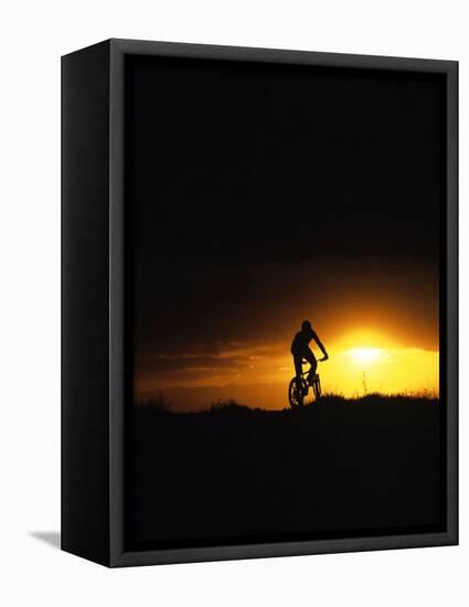 Mountain Biker Against Stormy Sunset, Fruita, Colorado, USA-Chuck Haney-Framed Stretched Canvas