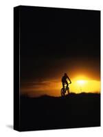 Mountain Biker Against Stormy Sunset, Fruita, Colorado, USA-Chuck Haney-Stretched Canvas