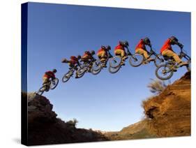 Mountain Biker Catches Air at Rampage Site near Virgin, Utah, USA-Chuck Haney-Stretched Canvas