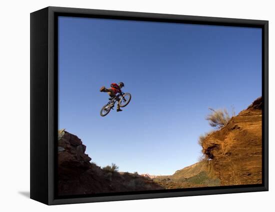 Mountain Biker Catches Air at Rampage Site near Virgin, Utah, USA-Chuck Haney-Framed Stretched Canvas