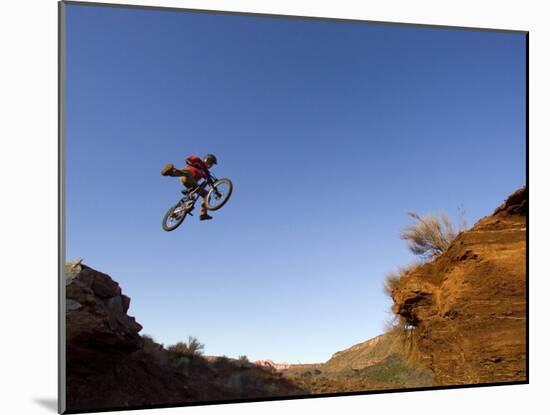 Mountain Biker Catches Air at Rampage Site near Virgin, Utah, USA-Chuck Haney-Mounted Photographic Print