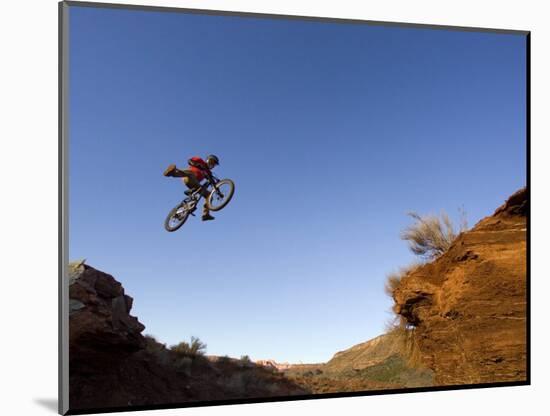 Mountain Biker Catches Air at Rampage Site near Virgin, Utah, USA-Chuck Haney-Mounted Photographic Print