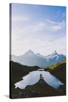 Mountain biker looking at Bachalpsee lake and Bernese Oberland mountains at dawn-Roberto Moiola-Stretched Canvas