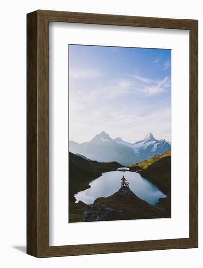 Mountain biker looking at Bachalpsee lake and Bernese Oberland mountains at dawn-Roberto Moiola-Framed Photographic Print