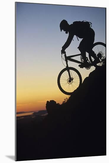 Mountain Biker Riding Down Slope-null-Mounted Photo