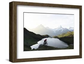 Mountain biker riding downhill at Bachalpsee lake at dawn, Grindelwald, Bernese Oberland-Roberto Moiola-Framed Photographic Print