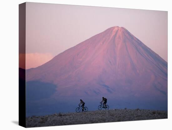 Mountain Biking in Atacama Desert Against a Backdrop of Perfect Cone of Volcan Licancabur 5916 M-John Warburton-lee-Stretched Canvas